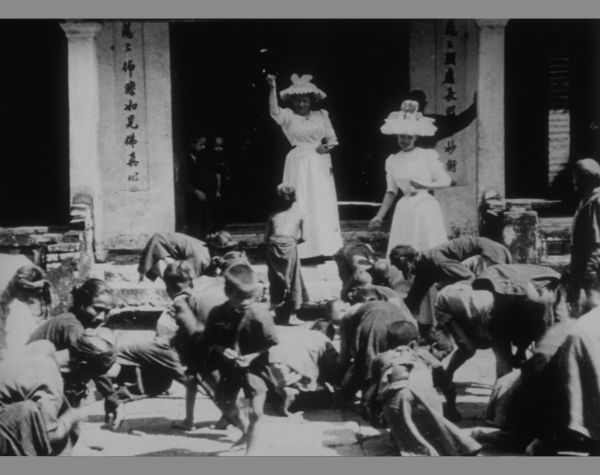 Indochina: Children Gathering Coins Scattered by Western Women
